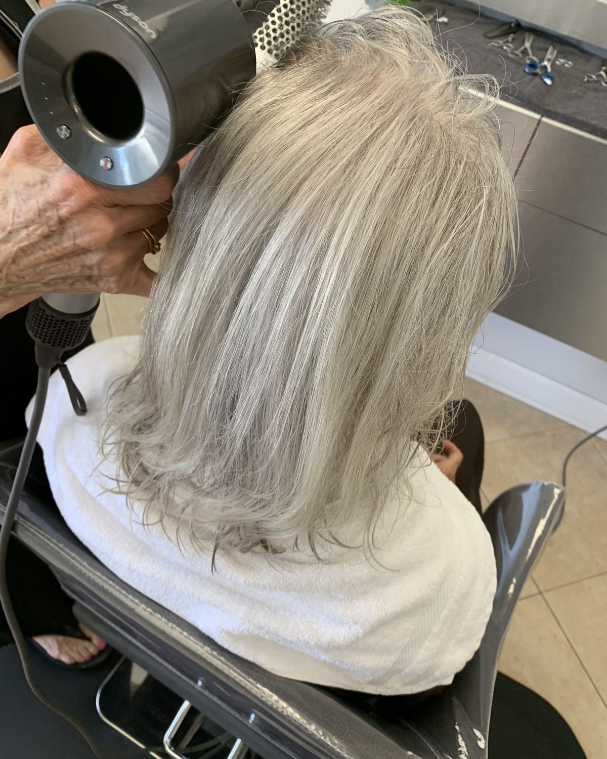 Platinum blonde being dried and finished — Toucheé Organic Salon, Juno Beach